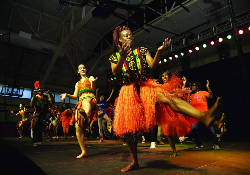 Energetic dancers in vibrant traditional costumes.