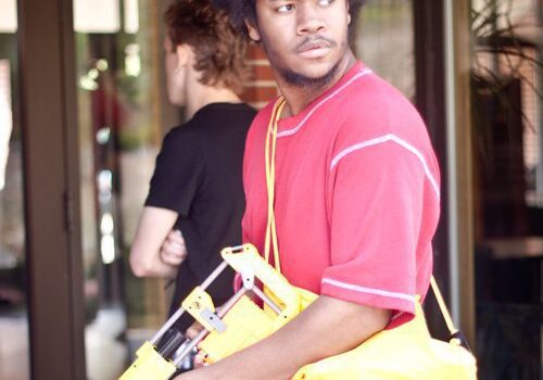 Man in red shirt with yellow Nerf gun