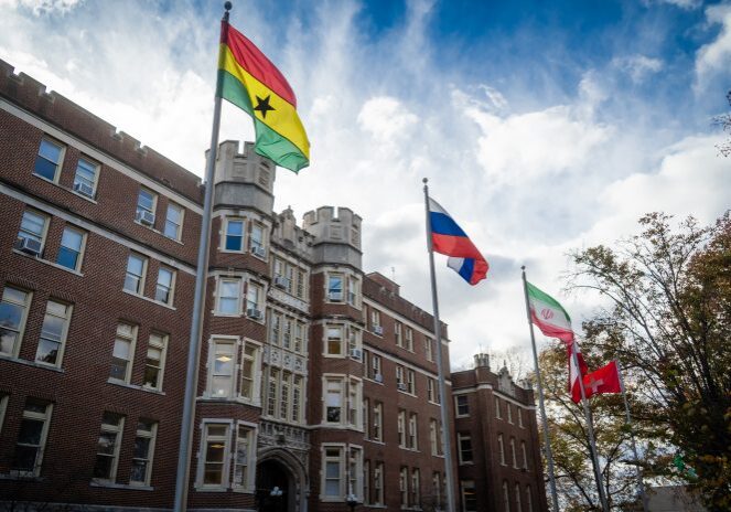 Cloudy sky over university campus flags