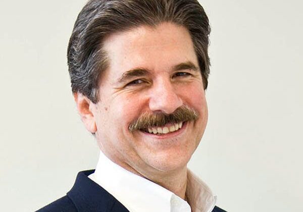 Man in a suit smiling