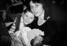Family cuddling in vintage photograph