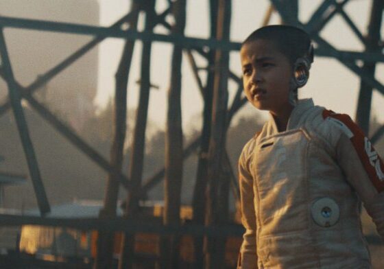 Young astronaut stands determinedly outdoors