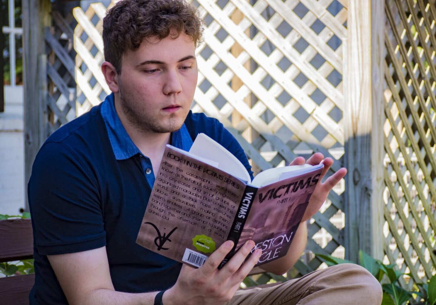 Man reading a book outdoors