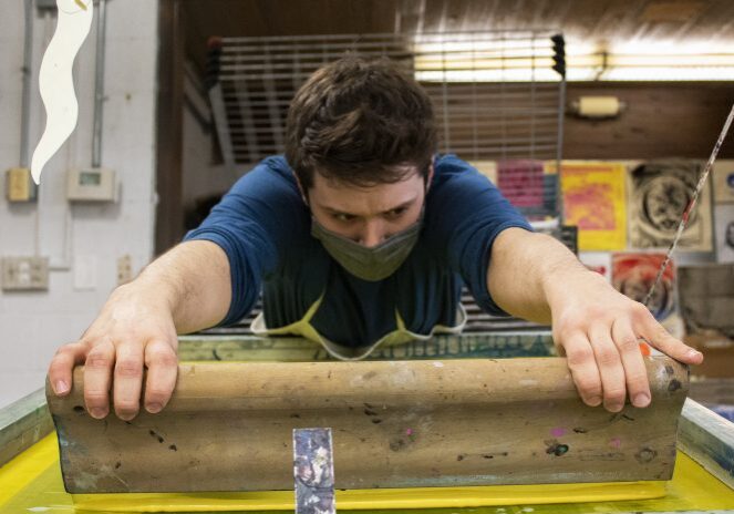 Man focused on screen printing