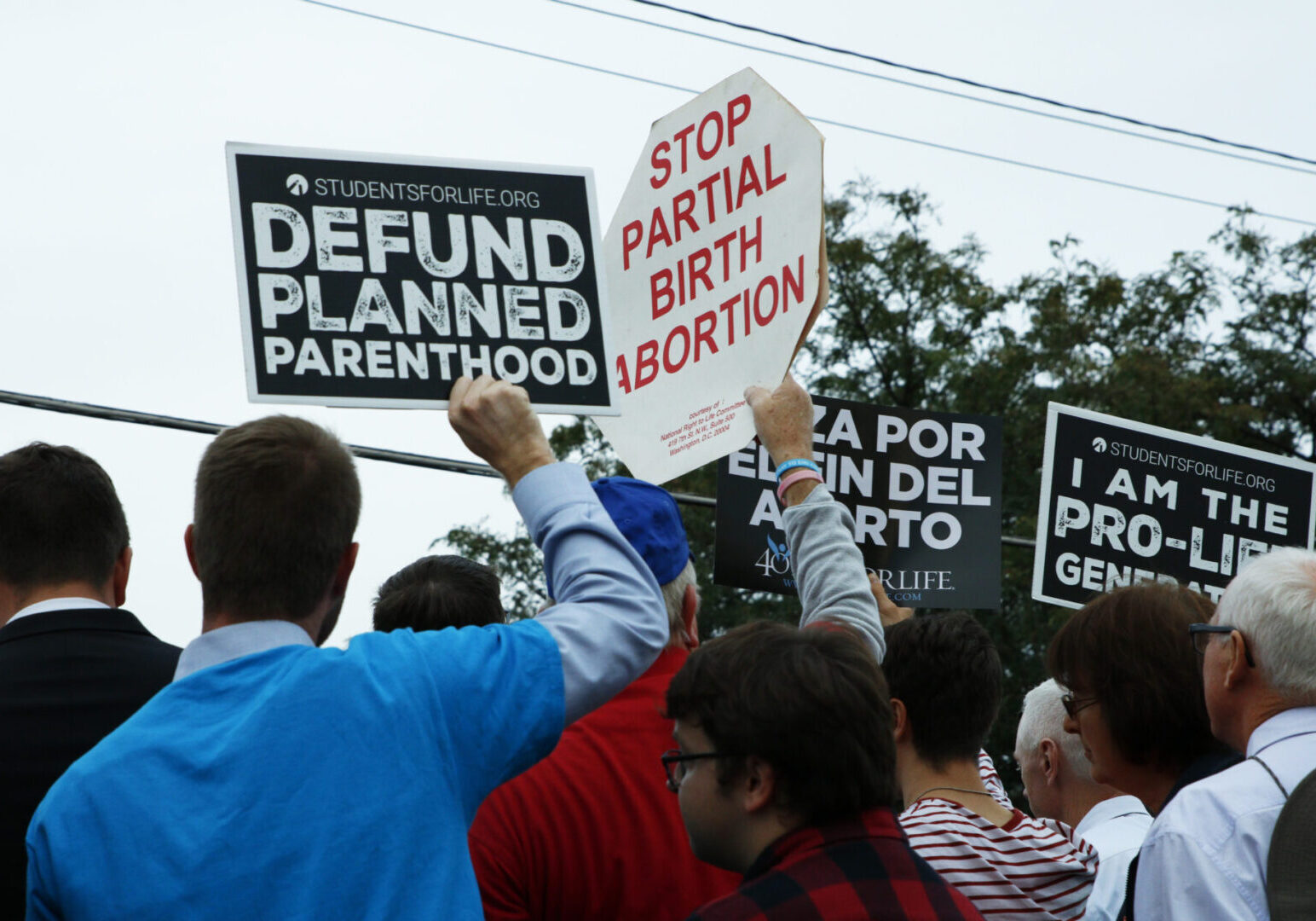 Protesters holding anti-abortion signs