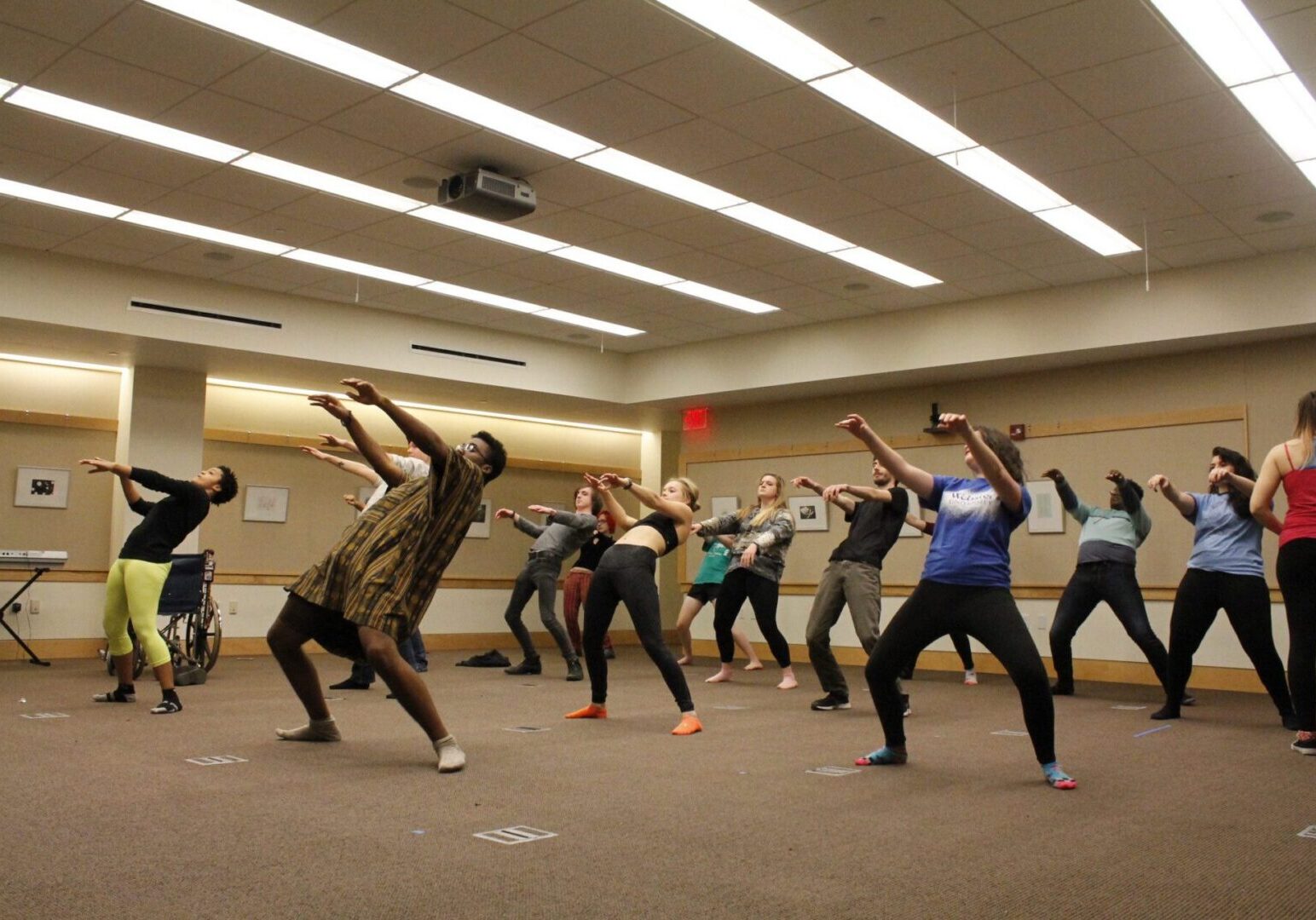 People rehearsing dance moves indoors