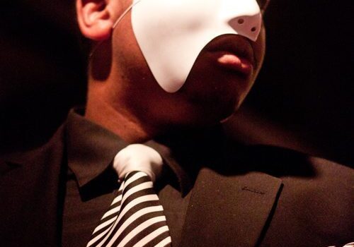 Mysterious masked man in formal attire.