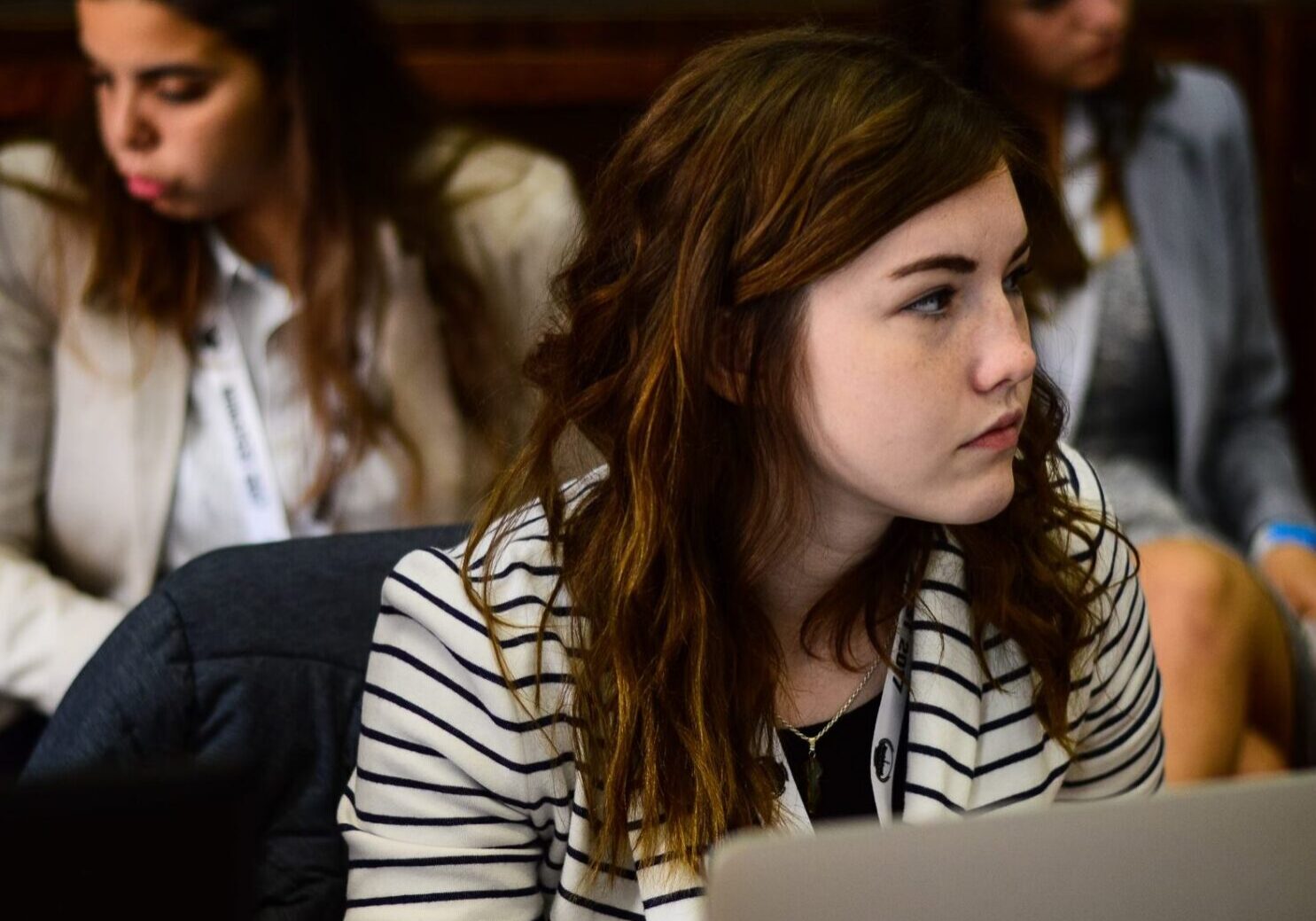 Focused woman in striped blazer