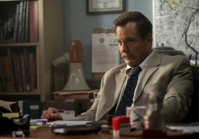Man in suit sitting at a desk
