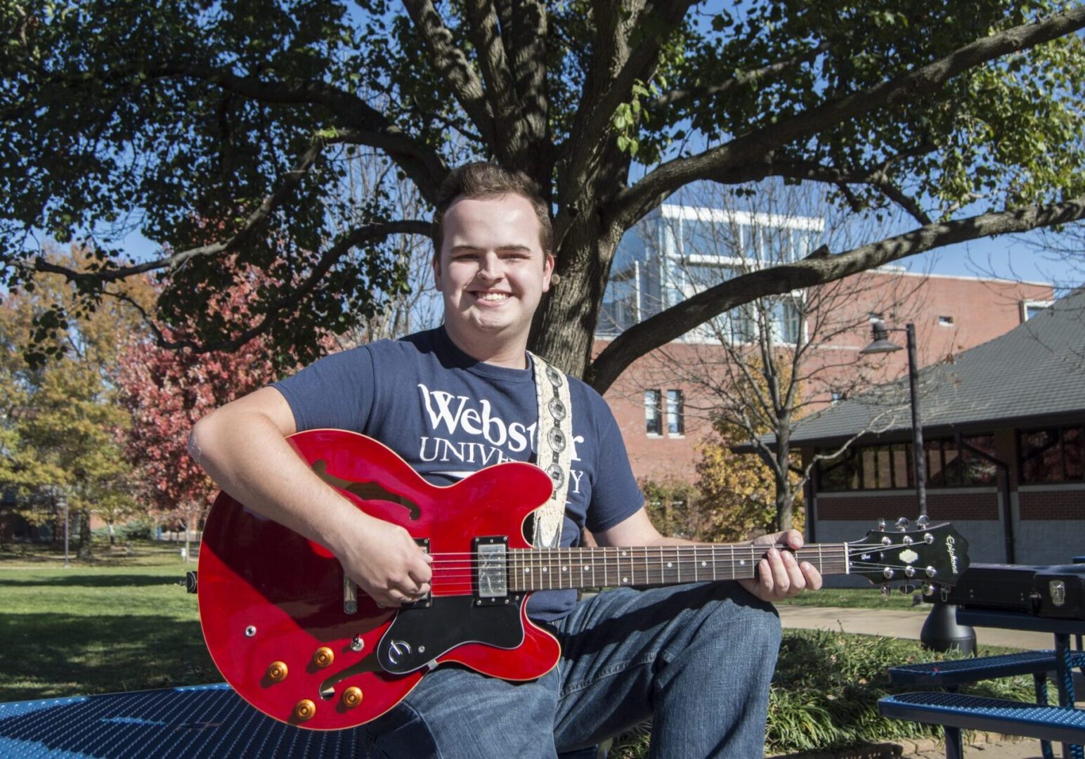 Outdoor music session with red guitar