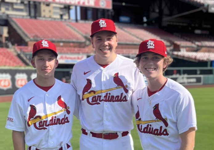 Three Cardinals team members on field