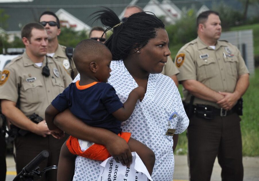 Mother and child with police officers