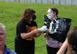 Two people in pie-throwing activity