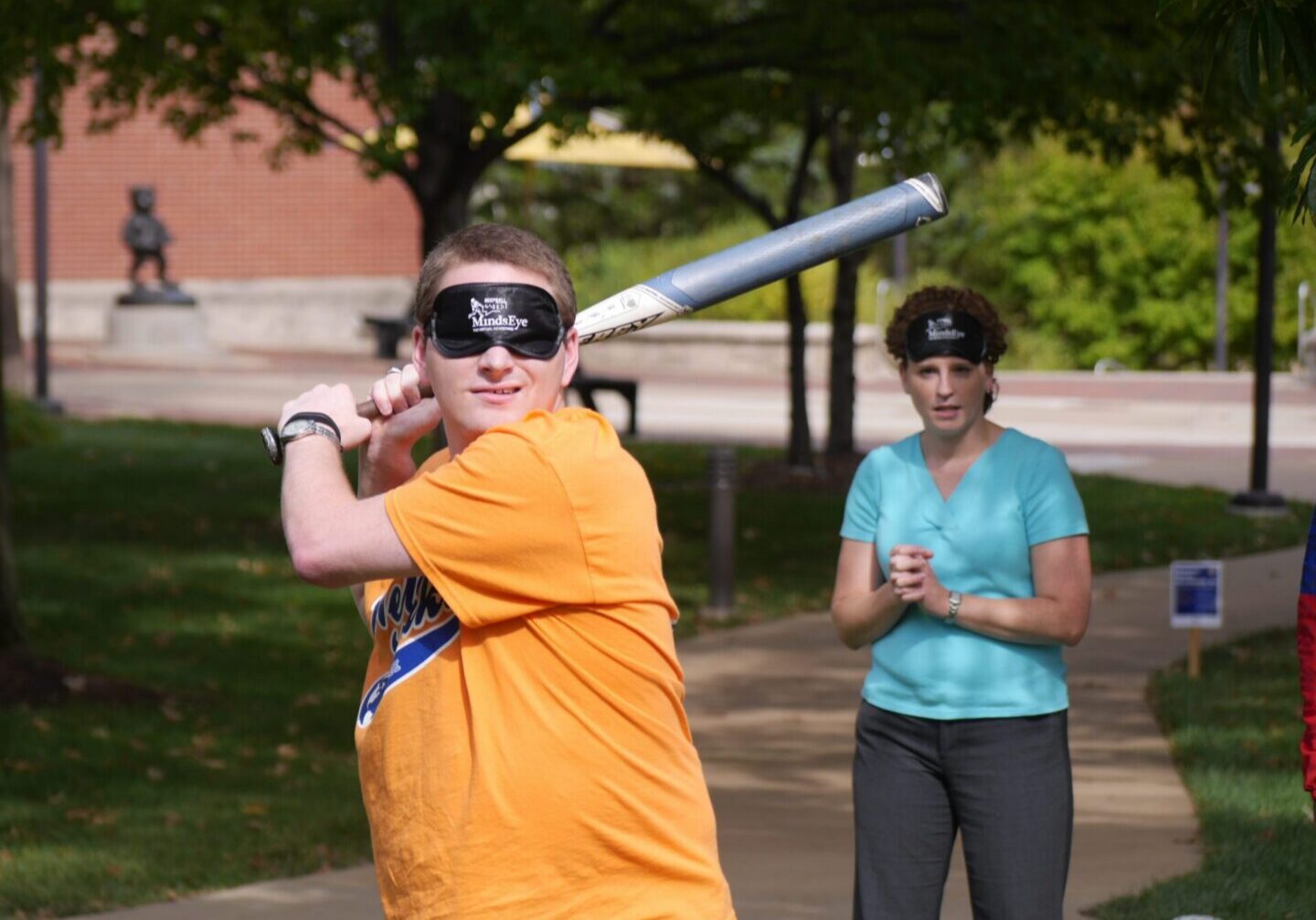 People participating in blindfolded baseball activity