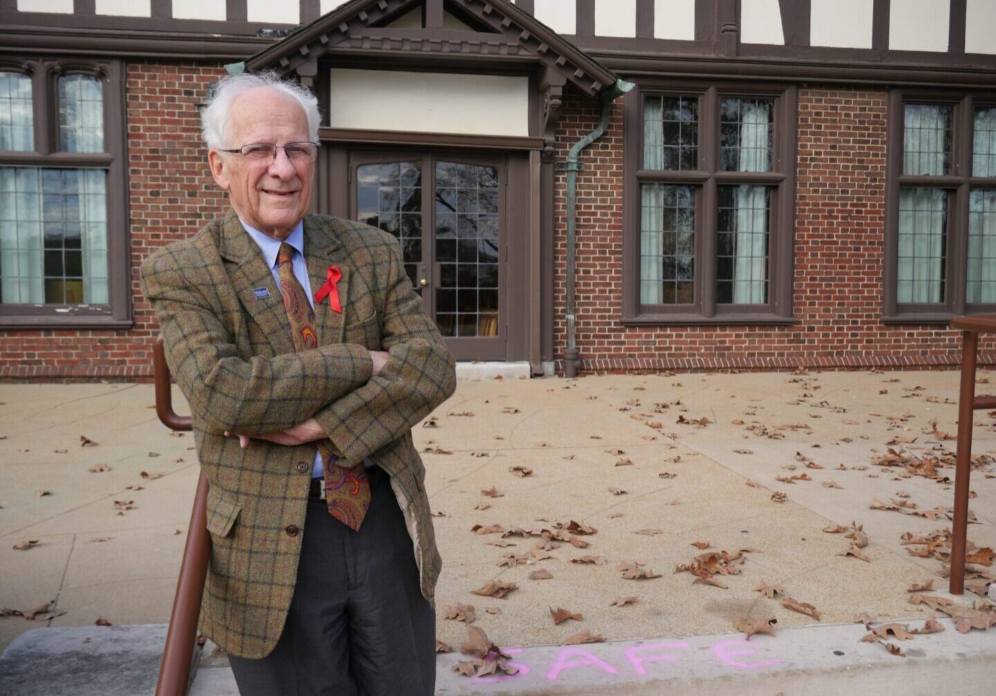 Senior in plaid jacket on sidewalk