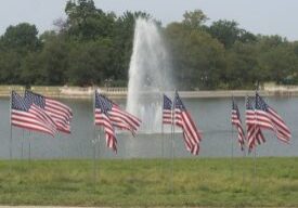 Flags waving near water fountain