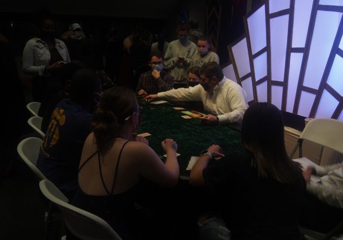 Players focused on a card game table.