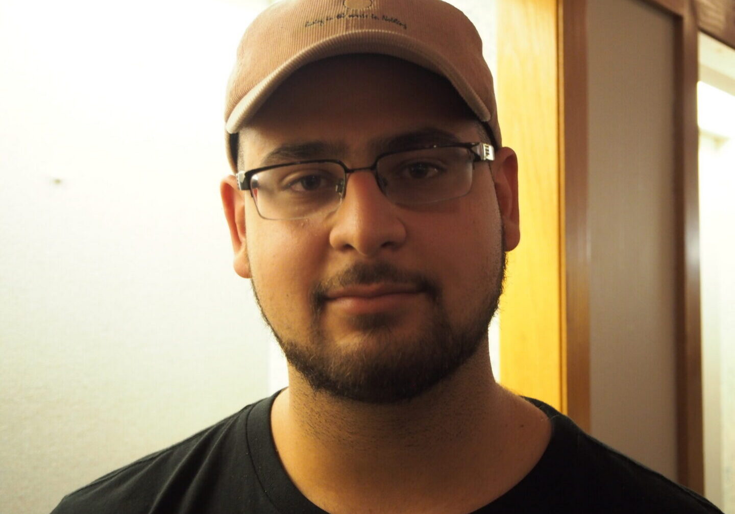 Person with beard, glasses, and cap