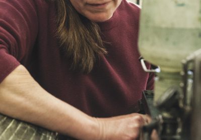 Woman working with industrial machine
