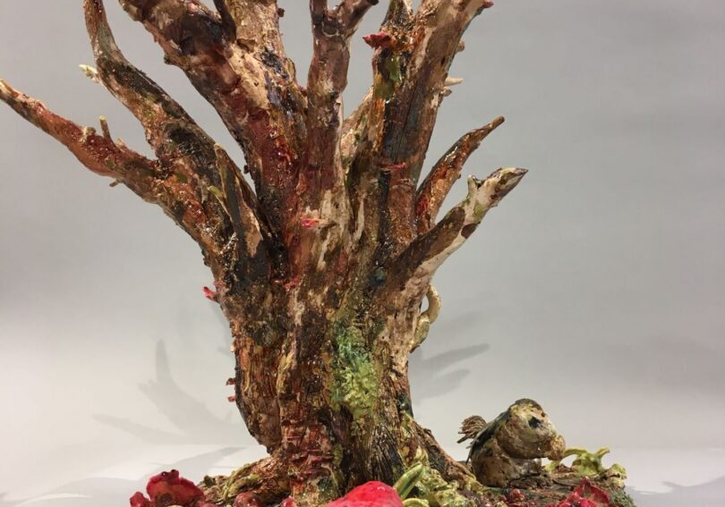 Tree sculpture featuring colorful natural elements