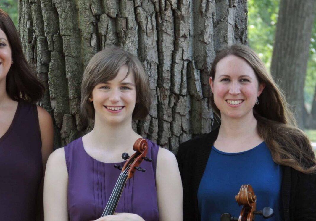 String quartet posing under a tree