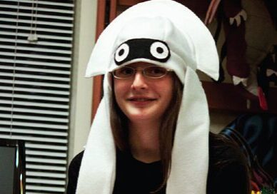 Woman in glasses sporting a fun hat