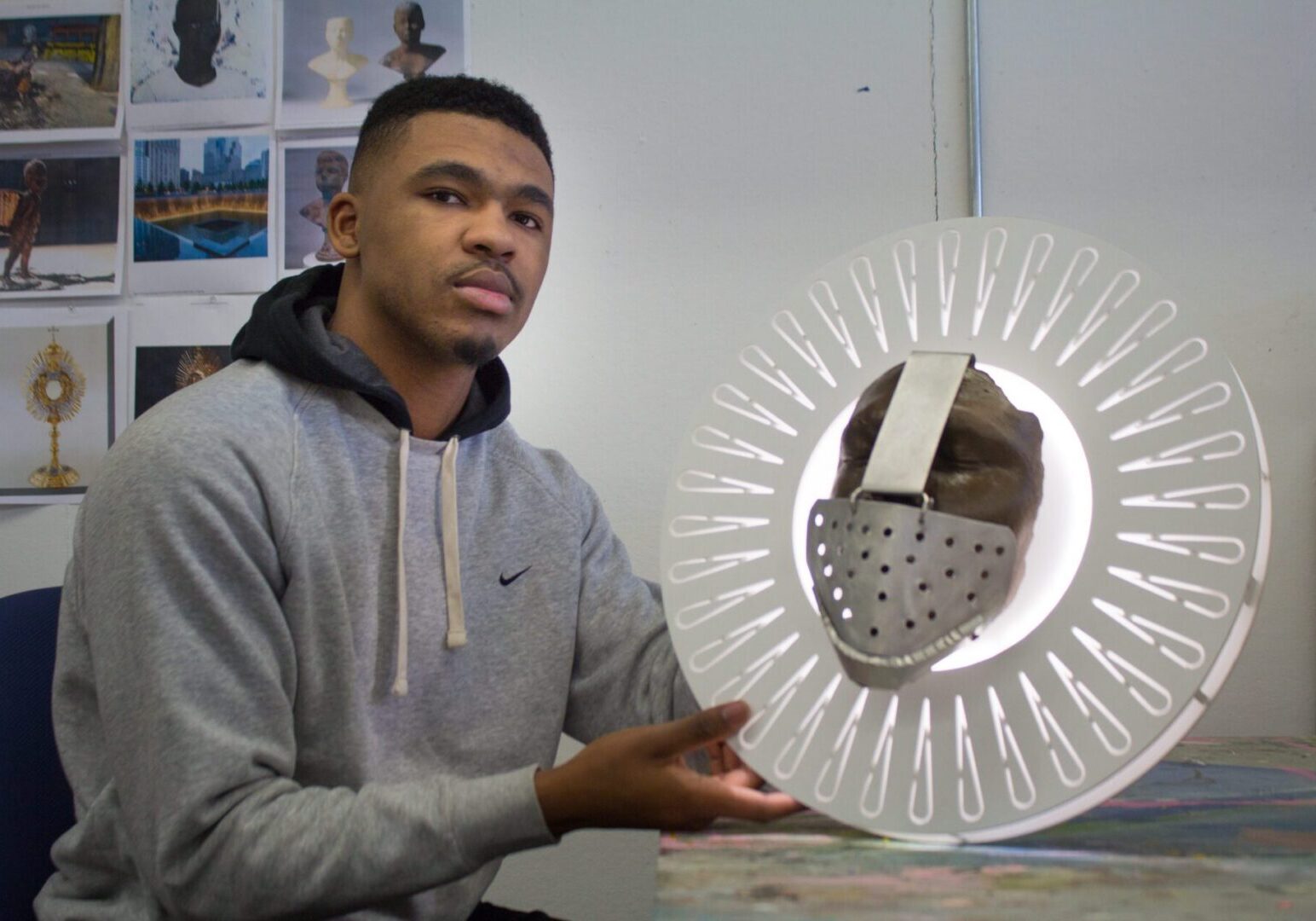 Man showcasing artistic mask creation