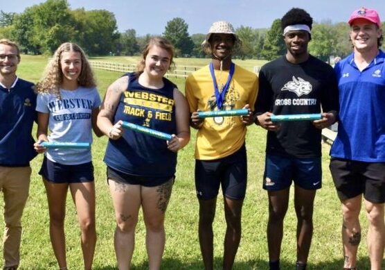 Track team posing on a sunny day