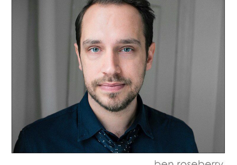 Portrait of a man against curtain backdrop