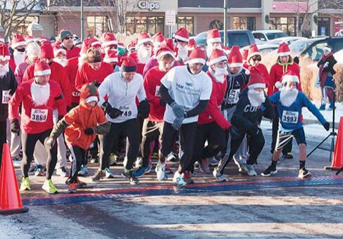 Runners in Santa costumes at race start