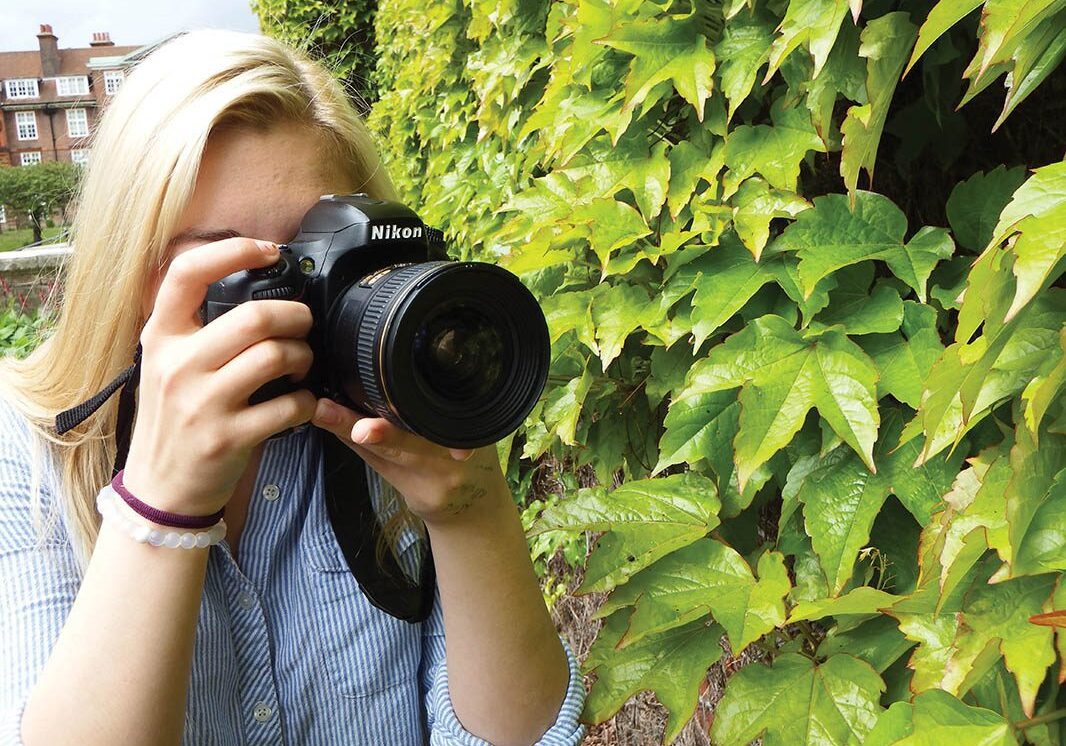 Person with camera photographing plants