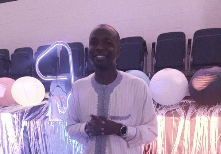Man smiling at decorated event