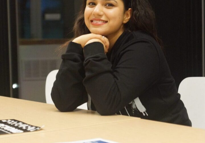 Person smiling at a table