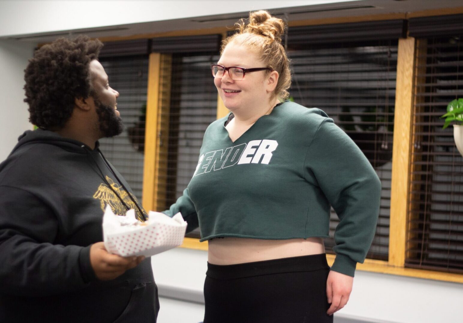 Man holding food, woman smiling