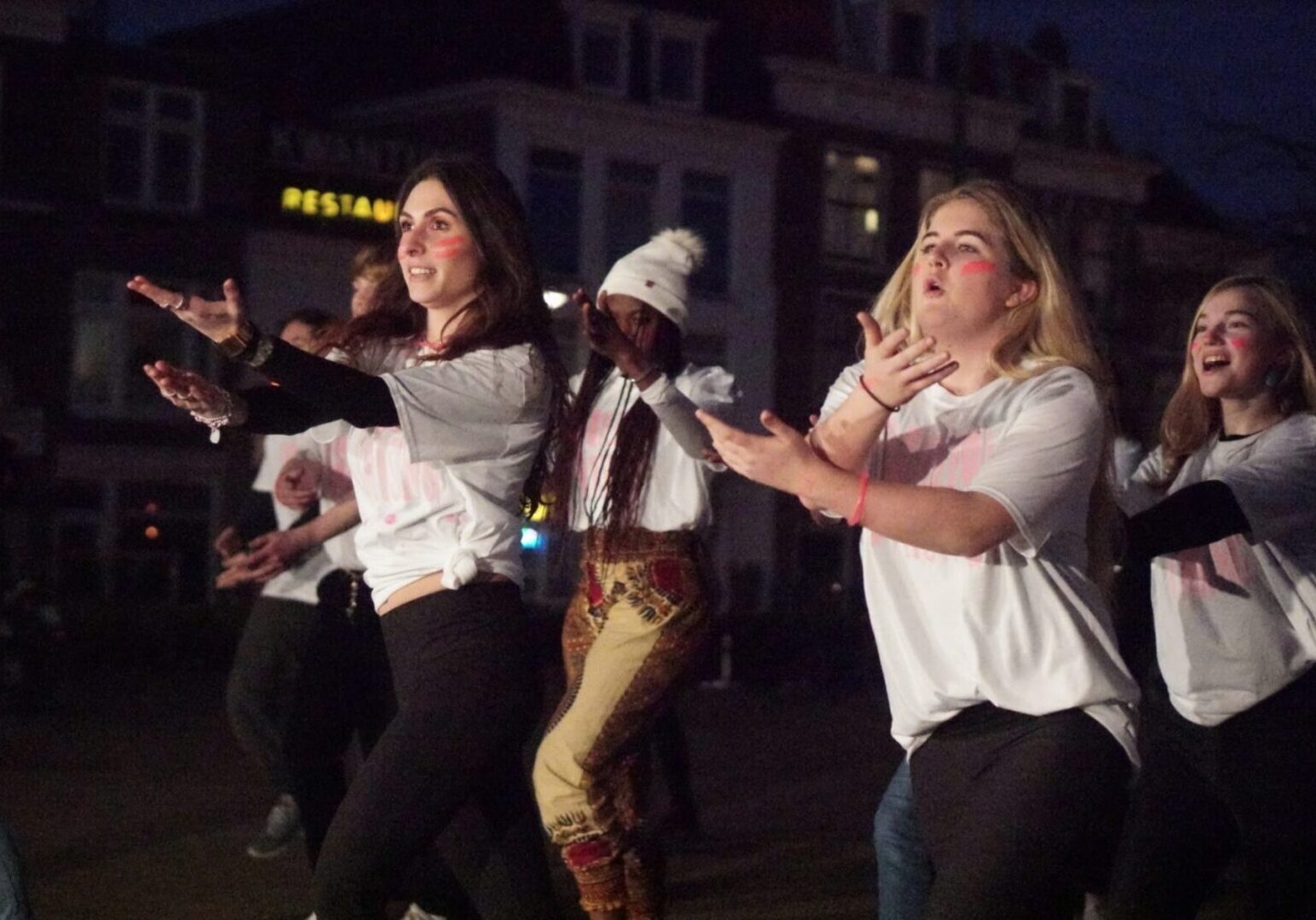 Group dancing energetically at night