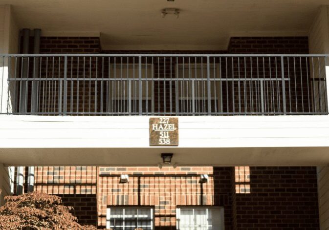 Sunlit apartment exterior with balcony railing