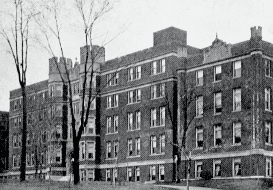 Historic brick building with many windows.