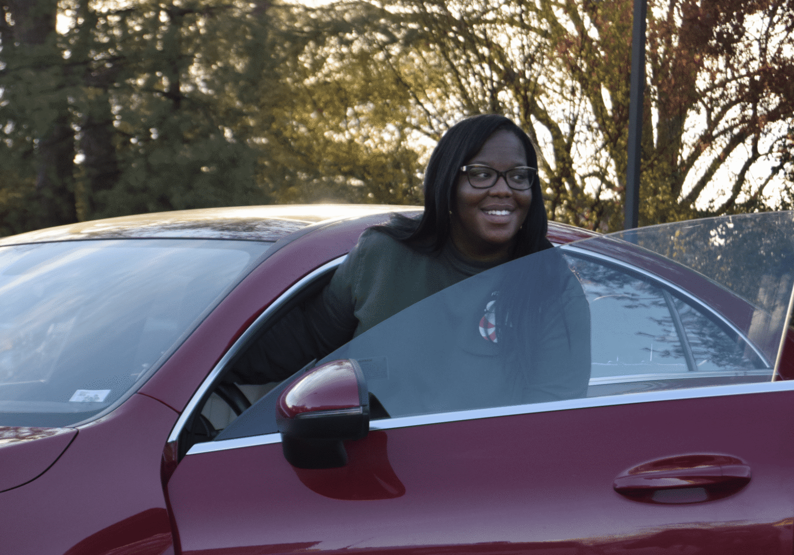 Individual leaving car with open door.