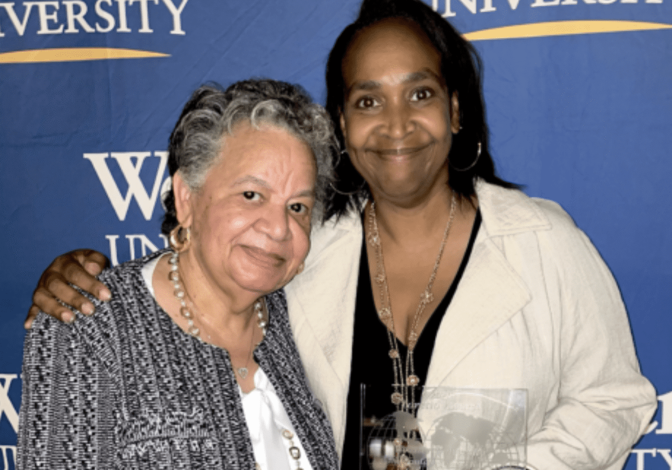 Women posing with awards at ceremony