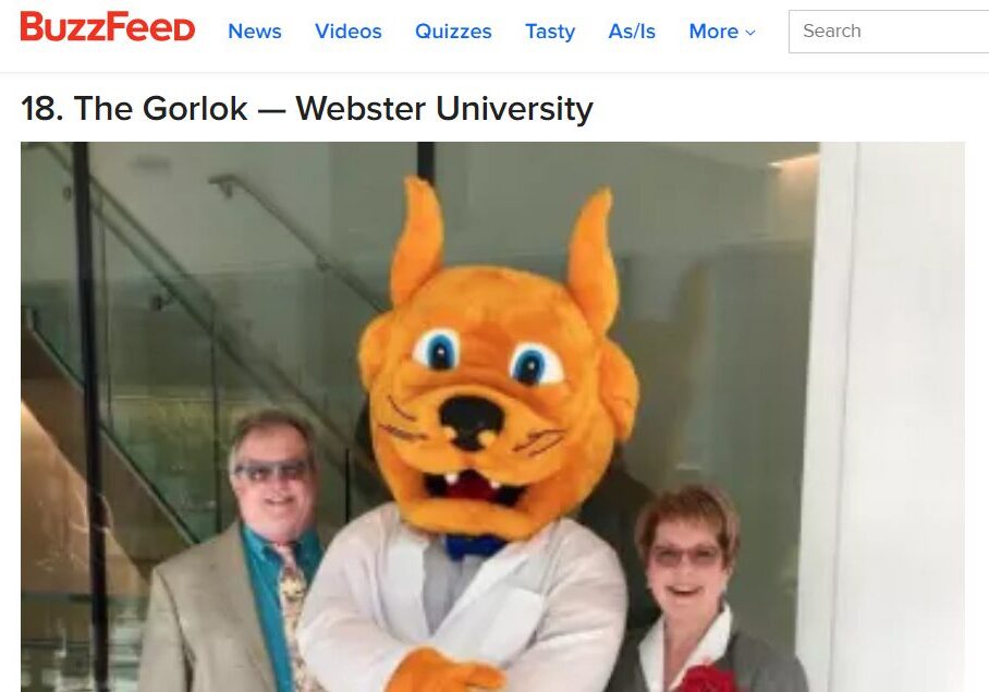 Mascot in white coat with two adults