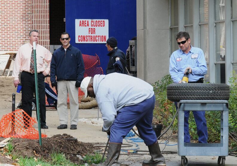 Workers repairing area near closed construction zone