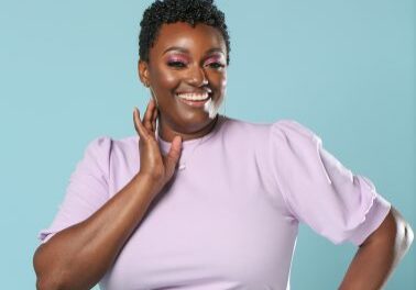 Confident woman posing against blue background