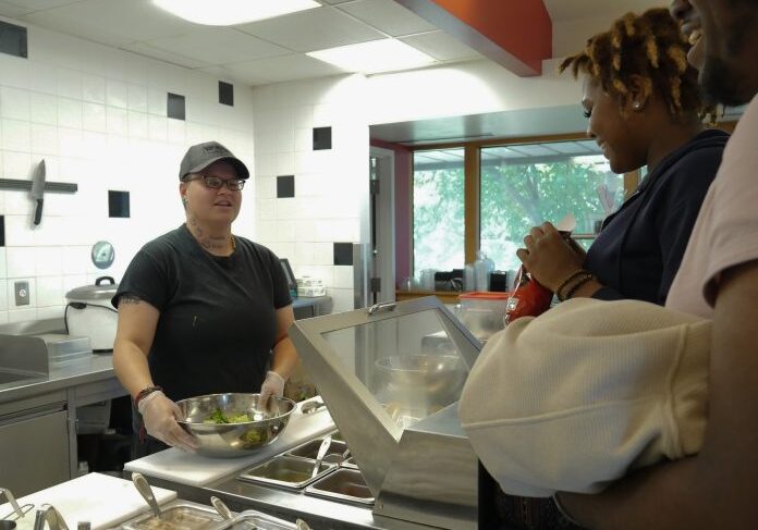 People ordering at a cafeteria counter