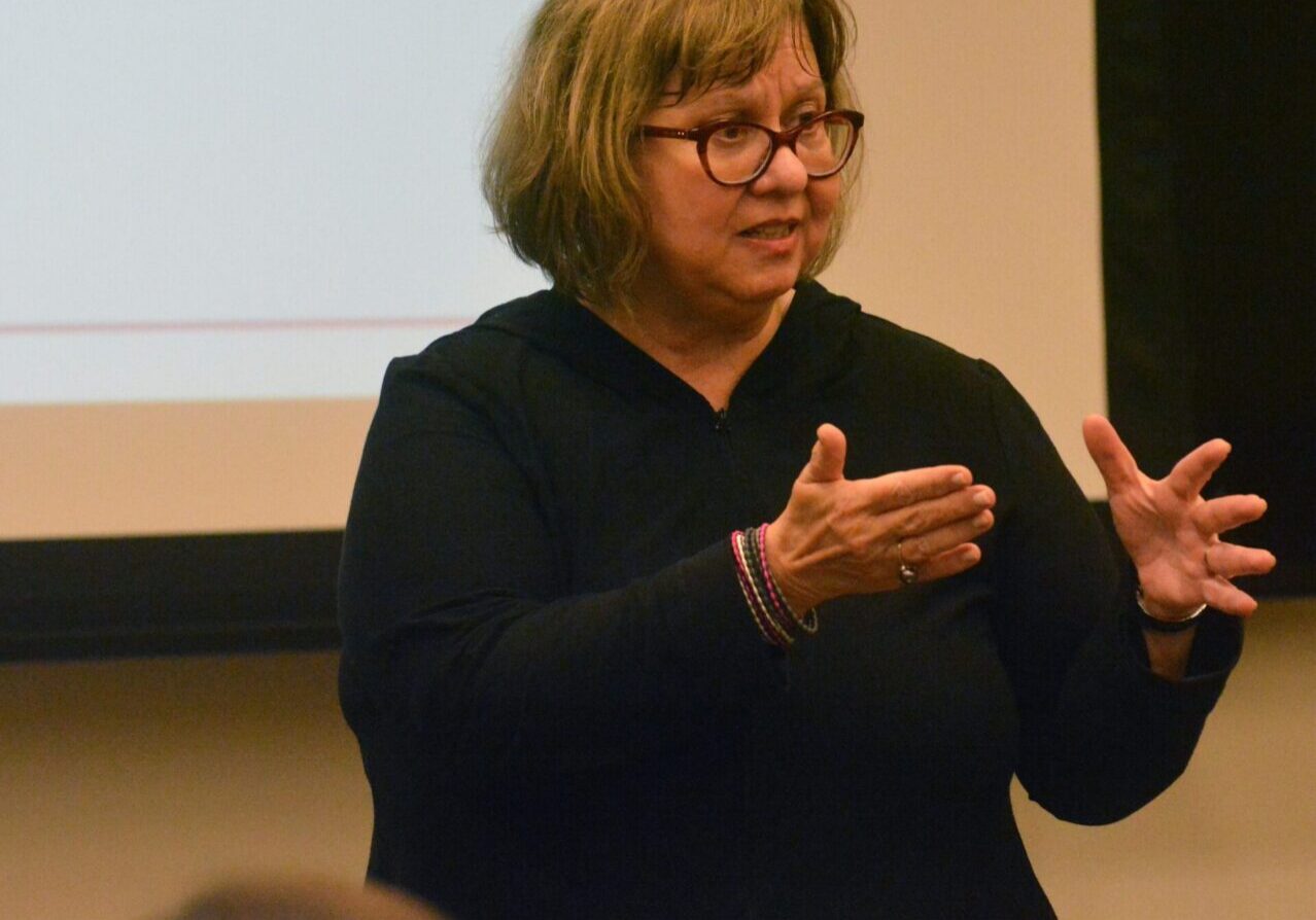 Speaker gesturing during a presentation.