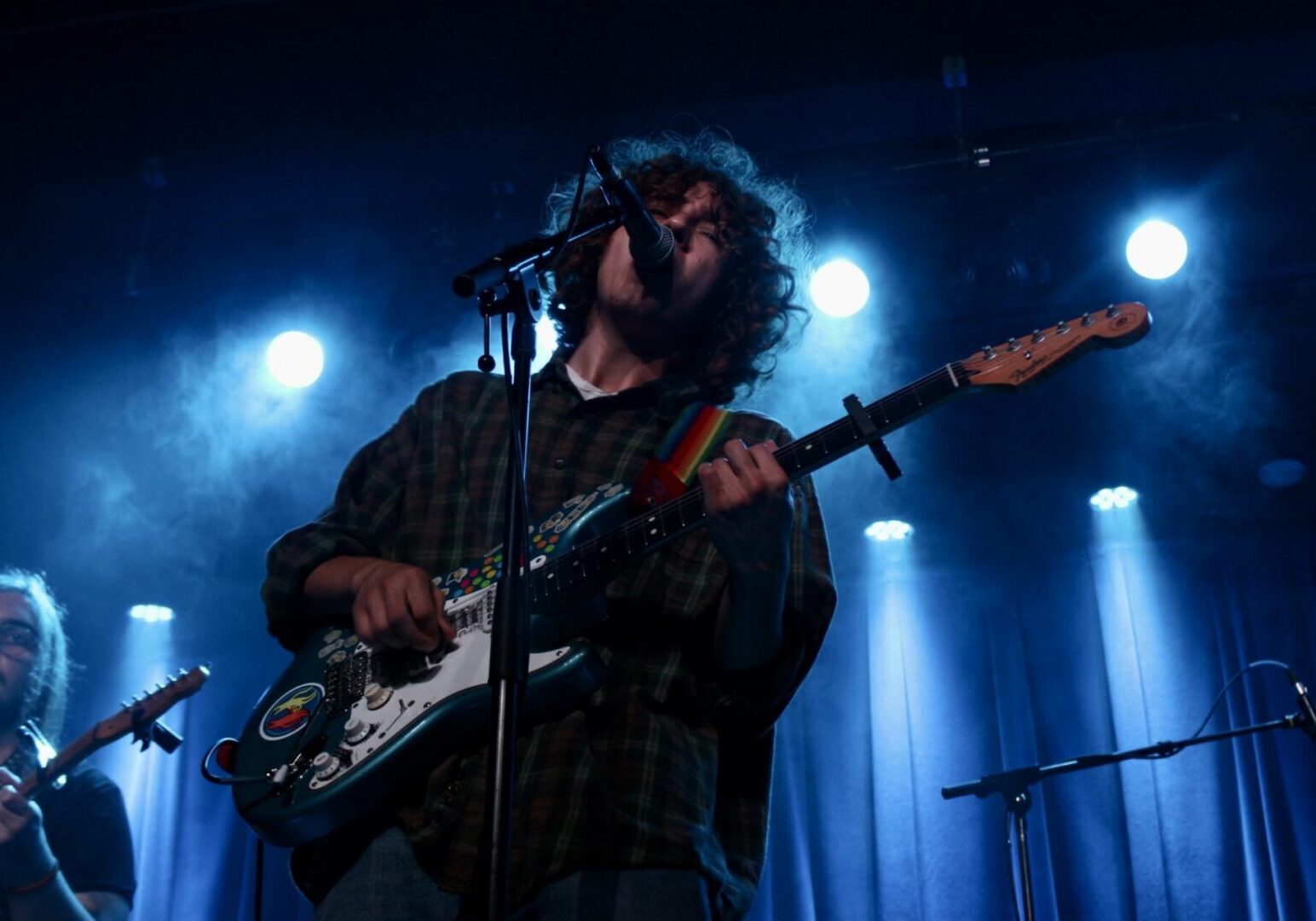 Musician performing with electric guitar on stage