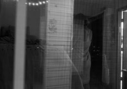 Black-and-white reflection of person in doorway