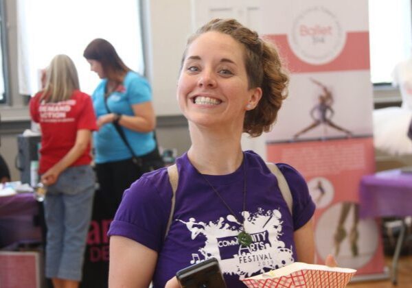 Woman smiling at community arts festival