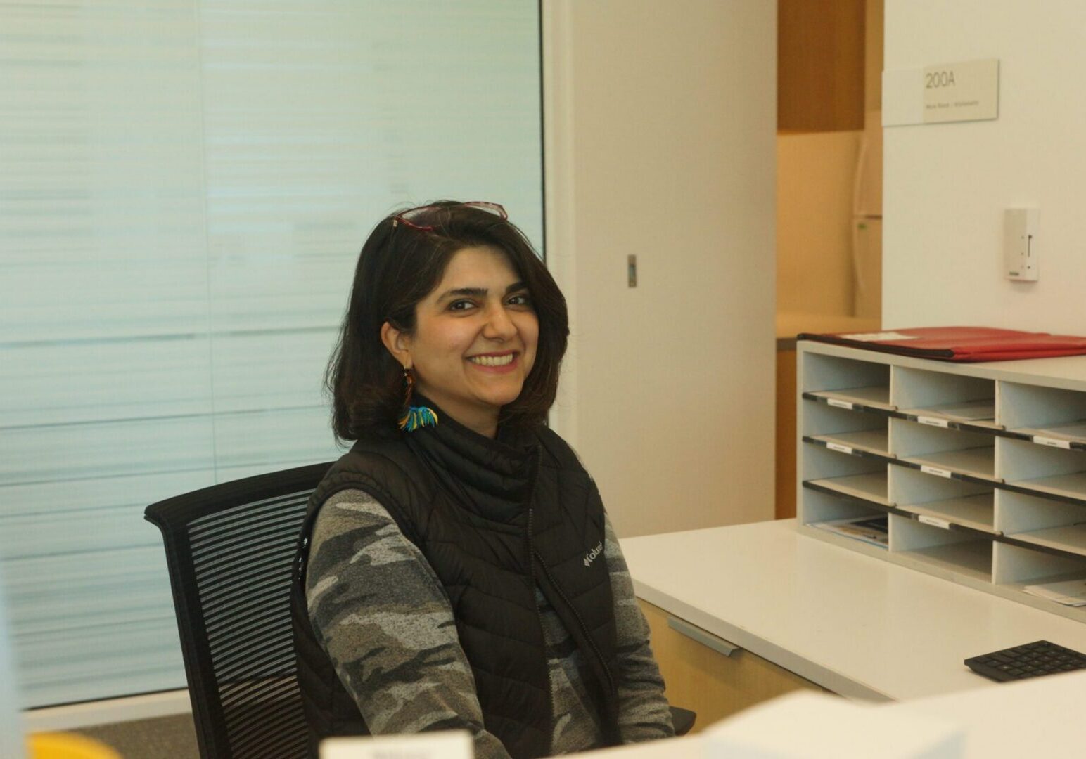 Woman in office setting smiling