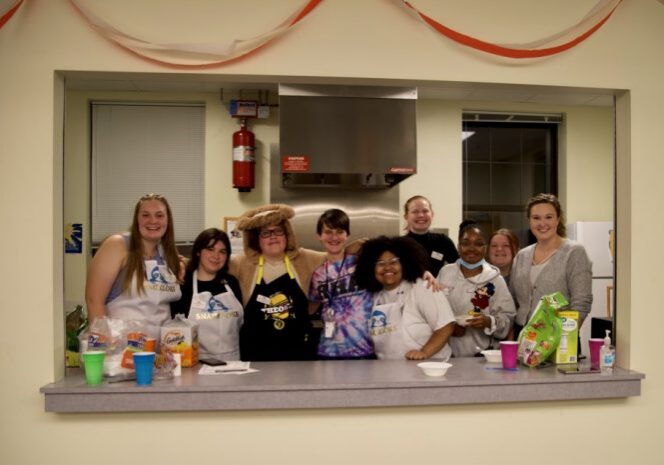 Smiling team behind a counter