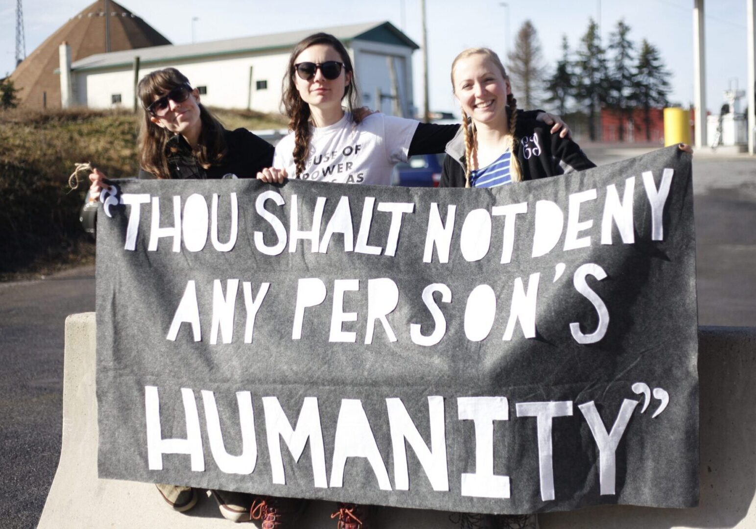 Group displaying a powerful message sign